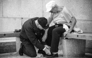 Elder-Man-Helping-Elder-Woman-to-Tie-Her-Shoes